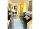 Comfortable green couch in a charming living room with views into the kitchen and hallways at 309 Meeting St # 19, Charleston, SC 29401