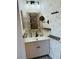 Charming powder room featuring floral wallpaper, vanity with sink, driftwood mirror and decorative shelves at 309 Meeting St # 19, Charleston, SC 29401