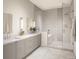 Spa-like bathroom featuring double sinks, modern vanities, and a glass-enclosed shower and tub at 325 Longshore St # 1143, Daniel Island, SC 29492