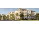 Charming condo building with multiple levels of balconies, surrounded by trees, plants, and landscaping at 325 Longshore St # 1143, Daniel Island, SC 29492