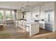 Modern open kitchen with stainless steel appliances, a large island with bar seating, and views to dining at 325 Longshore St # 1143, Daniel Island, SC 29492