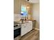 Farmhouse kitchen with white cabinets, wood countertops, and stainless-steel appliances at 377 Furman Ln, Ladson, SC 29456