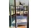 Screened-in patio showcasing a ceiling fan, brick accents, and view of the backyard at 377 Furman Ln, Ladson, SC 29456