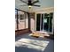Covered patio featuring a ceiling fan, brick accents, and sliding glass doors leading to the house at 377 Furman Ln, Ladson, SC 29456