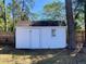 Well-maintained outdoor storage shed with a window and shingled roof in a tree-filled yard at 377 Furman Ln, Ladson, SC 29456
