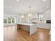 Open-concept kitchen with large island, modern appliances, white cabinetry, and plenty of natural light at 3846 Delinger Dr, Mount Pleasant, SC 29466
