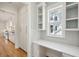 Kitchen featuring white cabinets, subway tile backsplash, hardwood floors, and a built-in desk area at 3846 Delinger Dr, Mount Pleasant, SC 29466