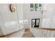 Upstairs landing with chandelier and staircase featuring wooden steps and white railings against white paneled walls at 3846 Delinger Dr, Mount Pleasant, SC 29466