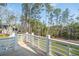 Inviting back deck with white railings offering picturesque views of the surrounding trees and landscape at 3866 Delinger Dr, Mount Pleasant, SC 29466