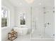 Modern bathroom with a standalone tub, glass shower, and serene forest views at 3866 Delinger Dr, Mount Pleasant, SC 29466