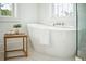 Bright bathroom showcases a modern freestanding tub with white marble floors and a leafy plant at 3866 Delinger Dr, Mount Pleasant, SC 29466