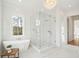 Bright bathroom features a glass shower, soaking tub under a window, and a modern chandelier at 3866 Delinger Dr, Mount Pleasant, SC 29466