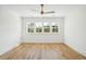 Spacious bedroom filled with natural light from large windows, featuring beautiful wood floors and a modern ceiling fan at 3866 Delinger Dr, Mount Pleasant, SC 29466