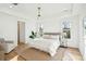 Bright bedroom featuring white walls, light wood floors, and stylish decor at 3866 Delinger Dr, Mount Pleasant, SC 29466