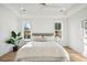 Well-lit bedroom with a tray ceiling, two windows, and a modern ceiling fan at 3866 Delinger Dr, Mount Pleasant, SC 29466