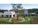 Modern building with landscaped grounds and a circular walkway, showcasing architectural design and curb appeal at 3866 Delinger Dr, Mount Pleasant, SC 29466