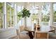 Bright dining area featuring a round wood table, wicker chairs, and scenic views at 3866 Delinger Dr, Mount Pleasant, SC 29466