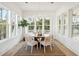 Sunlit dining area with wood table, wicker chairs, and natural light through large windows at 3866 Delinger Dr, Mount Pleasant, SC 29466