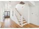 Bright entryway features hardwood floors, staircase, stylish lighting, and front door at 3866 Delinger Dr, Mount Pleasant, SC 29466