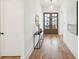Bright entryway boasts a wood floor, modern console table, and charming double doors with glass panes at 3866 Delinger Dr, Mount Pleasant, SC 29466