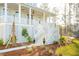 Inviting front porch with wooden stairs, stylish landscaping, and views of the neighborhood at 3866 Delinger Dr, Mount Pleasant, SC 29466