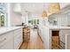 Spacious gourmet kitchen with custom cabinetry, pull-outs, and a seamless design into the dining area at 3866 Delinger Dr, Mount Pleasant, SC 29466