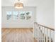 Bright landing area features hardwood floors, staircase, and large window at 3866 Delinger Dr, Mount Pleasant, SC 29466