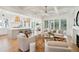 Spacious living room and kitchen area offer views of the manicured backyard through multiple windows at 3866 Delinger Dr, Mount Pleasant, SC 29466