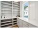 Walk-in pantry with white shelving, drawers, countertop space, and a view of the outside at 3866 Delinger Dr, Mount Pleasant, SC 29466