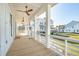 Spacious porch with wood flooring, white railings, ceiling fans and a view of neighboring homes at 3866 Delinger Dr, Mount Pleasant, SC 29466