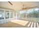Picturesque screened porch with a wood floor, ceiling fans, and scenic views of the green, wooded landscape at 3866 Delinger Dr, Mount Pleasant, SC 29466