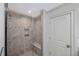 Modern bathroom features a tiled shower with a glass door and built-in bench and gray walls at 4 Falcon Point Rd, Kiawah Island, SC 29455