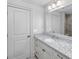 Bathroom featuring a granite countertop, white cabinets, and a well-lit mirror and a view to another room at 4 Falcon Point Rd, Kiawah Island, SC 29455