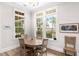 Cozy dining area featuring a round table, marsh views from the windows, and light-colored wood flooring at 4 Falcon Point Rd, Kiawah Island, SC 29455