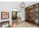 Grand entryway featuring hardwood floors, elegant lighting, and an inviting view into the dining room at 4 Falcon Point Rd, Kiawah Island, SC 29455