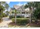 Charming two-story home with covered porch, set amongst mature palms and other trees at 4 Falcon Point Rd, Kiawah Island, SC 29455