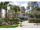 Charming home with a covered porch, beautiful landscaping, and a spacious driveway at 4 Falcon Point Rd, Kiawah Island, SC 29455