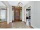 The foyer features wood floors, a chandelier and an entry door with sidelights at 4 Falcon Point Rd, Kiawah Island, SC 29455