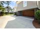 Attached two-car garage featuring wooden carriage doors and a wide concrete driveway at 4 Falcon Point Rd, Kiawah Island, SC 29455
