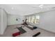 Bright home gym featuring large windows, a Peloton bike, and space for yoga, perfect for fitness enthusiasts at 4 Falcon Point Rd, Kiawah Island, SC 29455