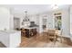 Well-lit kitchen with a central island, modern appliances, and a view into the living room with a fireplace at 4 Falcon Point Rd, Kiawah Island, SC 29455