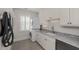 Laundry room with granite countertop and stacked laundry machines at 4 Falcon Point Rd, Kiawah Island, SC 29455