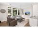 Bright living room with large windows, neutral furniture, built-in shelving, and a TV; perfect for relaxation at 4 Falcon Point Rd, Kiawah Island, SC 29455