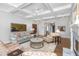Bright living room with coffered ceilings, stylish furniture, and hardwood floors creating an inviting space at 4 Falcon Point Rd, Kiawah Island, SC 29455