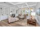 Spacious living room features marsh views, a fireplace, built-in shelves, and comfortable seating arrangements at 4 Falcon Point Rd, Kiawah Island, SC 29455