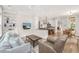 Bright living room open to the kitchen, with built-in shelving, a ceiling fan, and comfortable seating at 4 Falcon Point Rd, Kiawah Island, SC 29455