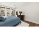 This main bedroom features a large bed, a dresser, and french doors that lead to a private outdoor balcony at 4 Falcon Point Rd, Kiawah Island, SC 29455