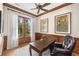 This office space includes wood trim, a large window with white curtains, and a wooden desk with a black leather chair at 4 Falcon Point Rd, Kiawah Island, SC 29455