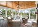 Cozy screened-in porch featuring ceiling fan, fireplace, and marsh views at 4 Falcon Point Rd, Kiawah Island, SC 29455
