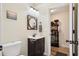 Functional half bathroom featuring a classic round mirror, modern sink, and door to the laundry room at 404 Terrier Rd, Goose Creek, SC 29445